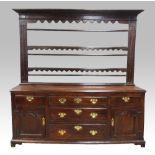 18th century oak dresser base with three central graduated drawers flanked by drawers and panelled