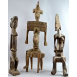 Baule-style carved wooded figures, including a female with plaited hair, 64 cm high, a pregnant