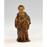 Carved wood figure of a Saint holding a book with traces of polychrome and gilt possibly Saint