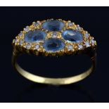 Aquamarine and diamond ring, the four oval stones set as a flower head, in a surround of small