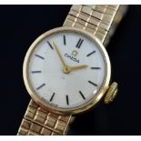 Omega ladies watch on integral articulated strap, 9 ct gold, boxed and with papers . The watch is in