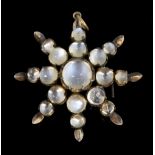 Vintage moonstone star form brooch, set in unmarked white metal, 3.7 cm . Gross weight 5.9