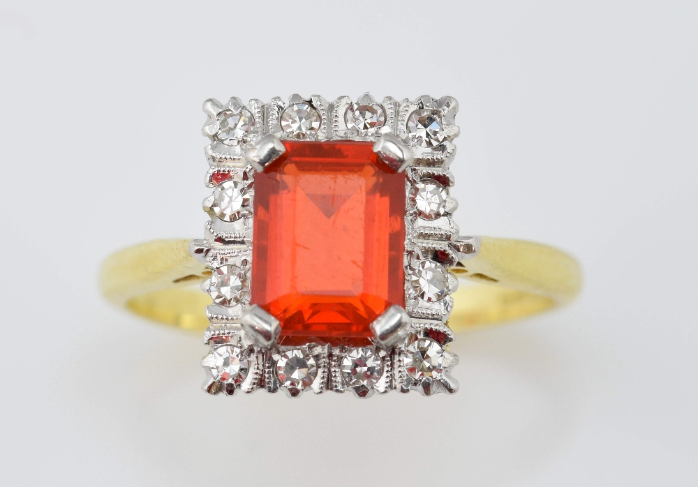 Fire opal and diamond set ring, set with central emerald cut stone, of approximately 1.00 carat