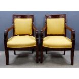 Pair of French Empire style mahogany open arm chairs,.