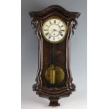 Single train wall clock with white enamel dial in glazed stained wood case. 75cm high and a black