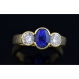 Sapphire and diamond three stone ring, the central sapphire of good colour, estimated at 1.30 carats