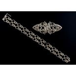 Art Nouveau style silver brooch and bracelet .