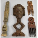 Selection of 20th century tribal items to include two wooden combs, 38 cm long, a flat carved mask