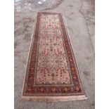 Cream ground Persian type runner with main red border centre with various foliate forms 288 x 100 cm