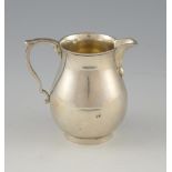 Modern silver cream jug of baluster form on round foot, by Spink & Son, London, 1972, 7.2oz, 226g,.