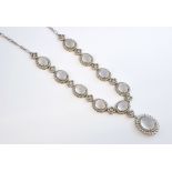 Moonstone cluster necklace, nine oval cabochon cut moonstones, surrounded by round cut cubic