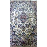 Cream ground Kashmir rug with floral borders, the centre with a lozenge shaped medallion 200cm x