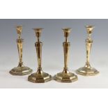 Set of four George V silver candlesticks of octagonal section, by Crichton Brothers, London,