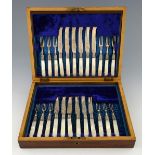 Set of twelve Victorian silver and mother of pearl handled fruit knives and forks with engraved