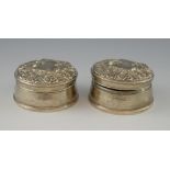 Pair of modern silver circular trinket boxes, the covers with embossed scrolling decoration, by W