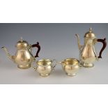 Modern silver four piece tea and coffee service, comprising tea pot, coffee pot, cream jug and sugar