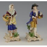 Pair of early 20th century German porcelain figures, modelled as a man and woman holding dead