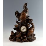 Late 19th century German carved wood Black Forest mantel clock decorated with black grouse, two