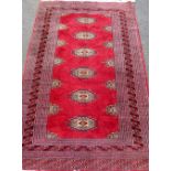 Persian style red ground runner with six central medallions and multiple borders with geometric