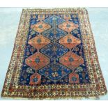 Persian Blue Ground Carpet with multiple floral borders, centre with repeating stepped lozenge