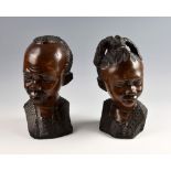 Pair of African carved hardwood heads of a man and a woman, 32cm high, .