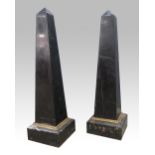 Pair of polished slate and marble obelisks with gilt metal mounts, 106 cm high .