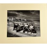 § Don McCullin, Silver Gelatin print of four people seated in deckchairs on the front at Eastbourne,