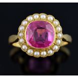 Gold ring set with a pink synthetic sapphire within a border of pearls, central stone estimated at