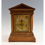 Oak cased triple train mantel clock, the silvered chapter ring with Roman and Arabic numerals,