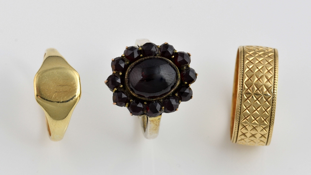 Garnet cluster ring with two gold rings, oval cabochon cut garnet surrounded by rose cut garnets,