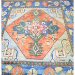 Large Persian design carpet, the blue ground with central lozenge and geometric borders. 470cm x