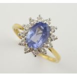 Sapphire and diamond cluster ring, oval cut sapphire, estimated weight 2.50 carats, surrounded by