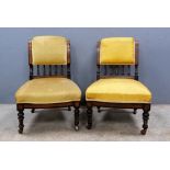 A pair of late 19th century boudoir chairs with mustard upholstery, 64cm high .