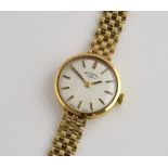 Rotary, a ladies wrist watch with mechanical movement, white dial with gold batons on a 9ct case and