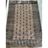 Pink ground Afghan type rug with multiple borders and repeating geometric patterns, .