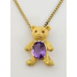 Teddy bear brooch pendant, oval cut amethyst, estimated weight 5.68 carats, with ruby set eyes and