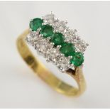 Emerald and diamond ring, five round cut emeralds centrally set in a row, estimated total weight 0.