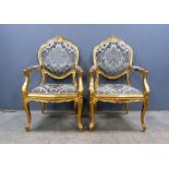 Pair of Louis XVI style fauteuils with shell and leaf decoration and stuff over upholstered seats,