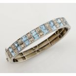 Aquamarine and diamond oval bangle, sixteen square cut aquamarines, estimated total weight 4.65