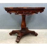 19th century rosewood foldover card table on carved column support, quatrefoil base and scroll feet,