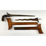 Malayan Kris with carved hardwood handle and another lacking handle.