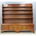 Early 20th century mahogany waterfall bookcase the base with cupboard doors and small drawers