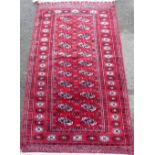Two Afghan type red ground rugs, 140x90cm & 170x100cm.