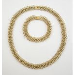 Gold fancy link chain necklace and bracelet, with three rows of circular links to a box clasp,9 ct