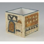 Troika cube vase with raised and incised design in blue and ochre, 8 x 9 x 9 cm .