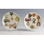 Piero Fornasetti, Italian 1913-1988 - Al Merito, circa 1960, two display plates. Each printed in