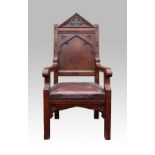 Gothic Revival oak armchair carved with arch, quatrefoil and trefoil motifs, upholstered leather