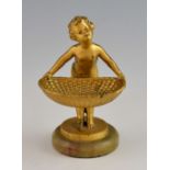 Gilt-metal figure of a putto carrying an open basket, on green onyx base, unsigned, 15 cm high.