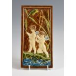 Villeroy & Boch, a tile depicting cherubs and a fish stamped VB to reverse, 18 x 31 cm. Glazed area