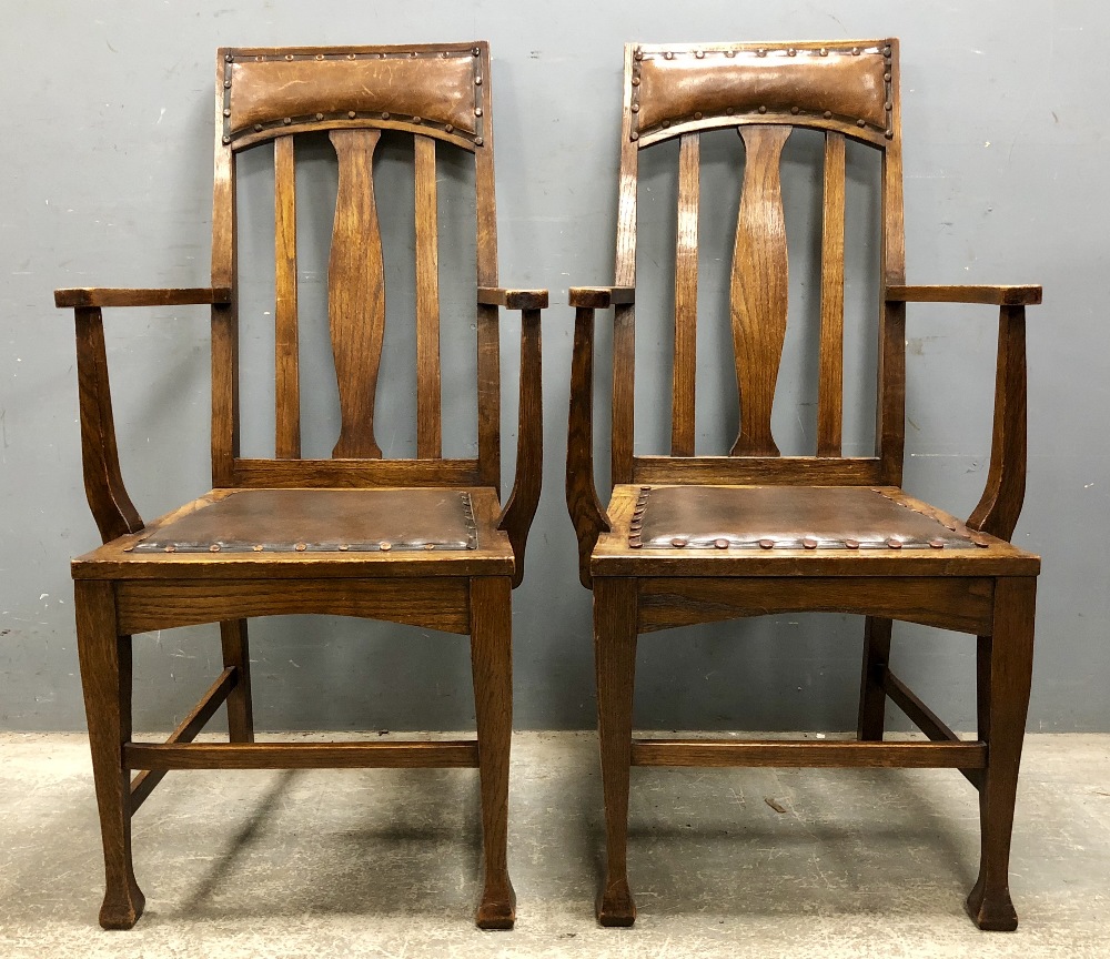 Set of ten oak dining chairs including two carvers Arts and Crafts influence design with upholstered